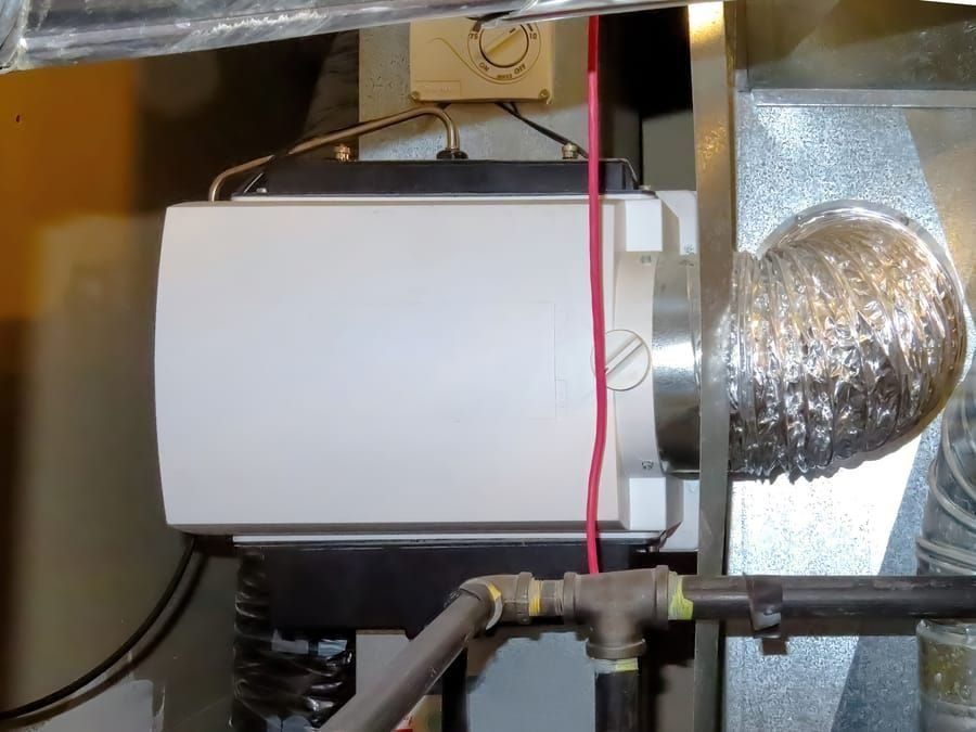 whole-house HVAC humidifier attached directly to a furnace duct system.