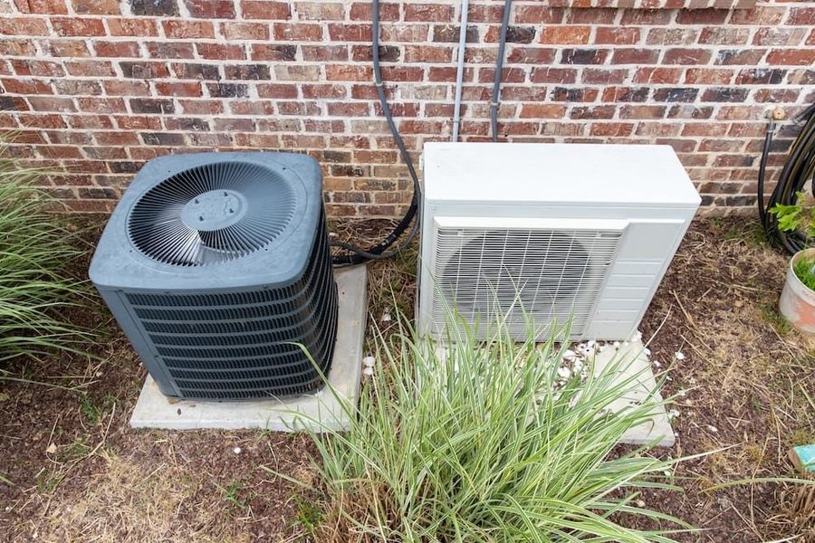 AC unit & heat pump outside a Garner home