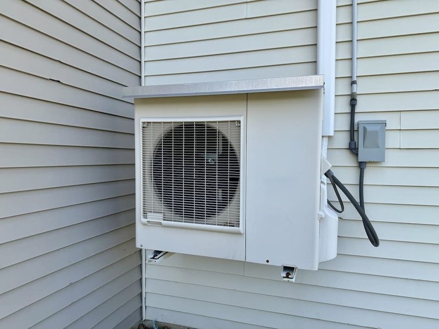 Heat pump connected to the side of a house