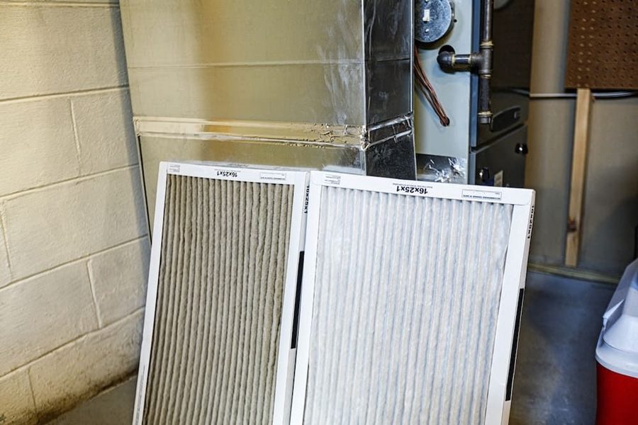 Furnace filter being replaced as part of its regular maintenance